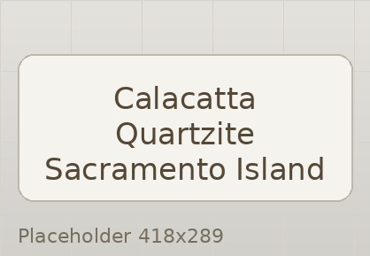 Calacatta quartzite kitchen island with waterfall edge and bright cabinetry